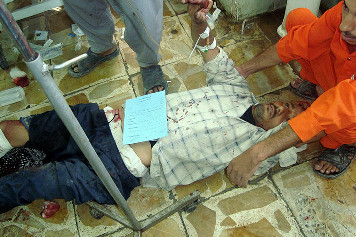 Baghdad bombing: A wounded man receives first aid treatment at the emergency ward, Baghdad