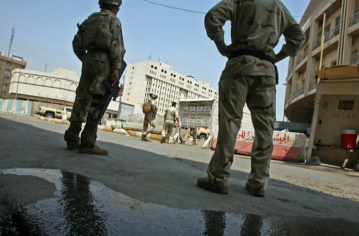 Baghdad bombing: Iraqi soldiers stand guard outside an army recruitment centre in Baghdad