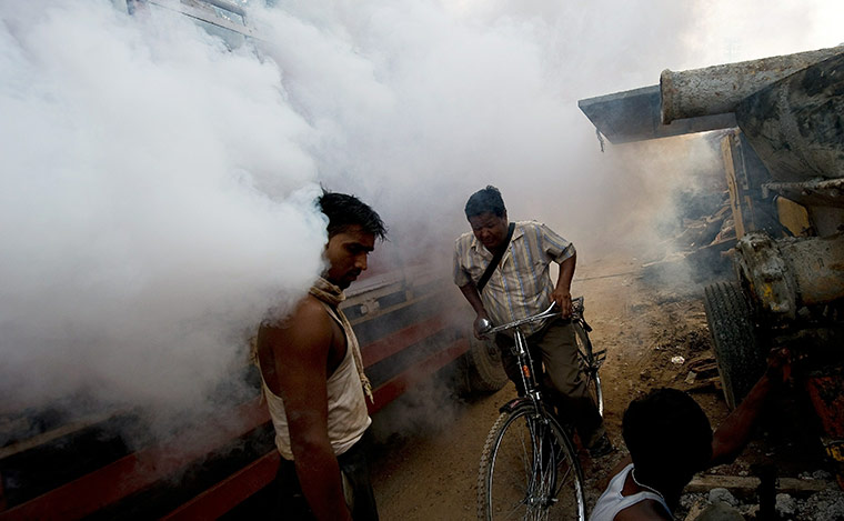 24 hours in pictures: New Delhi Municipal Council workers fumigate mosquitoes