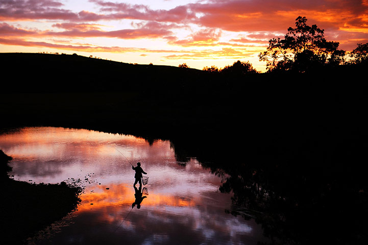 24 hours in pictures: A lone fisherman casts his line in  the River Coquet, Rothbury