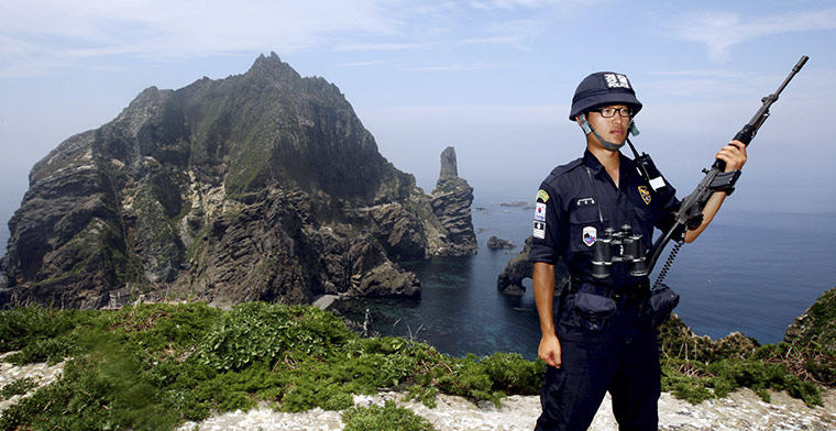 Korean Islands: A South Korean police officer stands guard on Dokdo islands