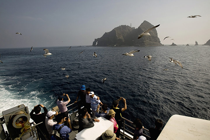 Korean Islands: Tourists take photos of the Dokdo Islands, known to Japanese as Takeshima