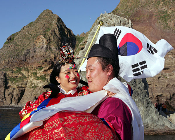 Korean Islands: South Korean Kim Jong-bok hugs his bride Song Hee-jung 