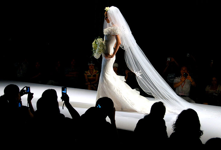 Week in Business: A model at the Shanghai Wedding Photographic Equipment Exhibition 