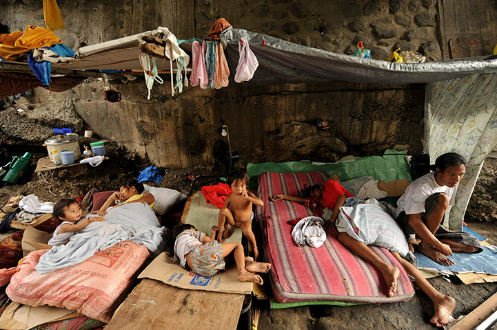24 hours:  Filipinos rest at their shanty home under a bridge