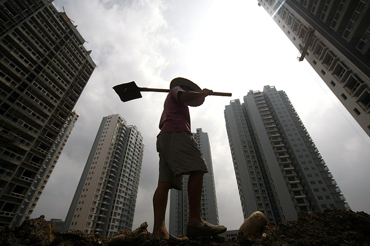 Week in Business: A Chinese worker at a construction site in Suining China