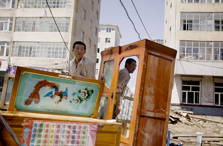 24 hours in pictures: A Chinese man salvages his belongings after flooding