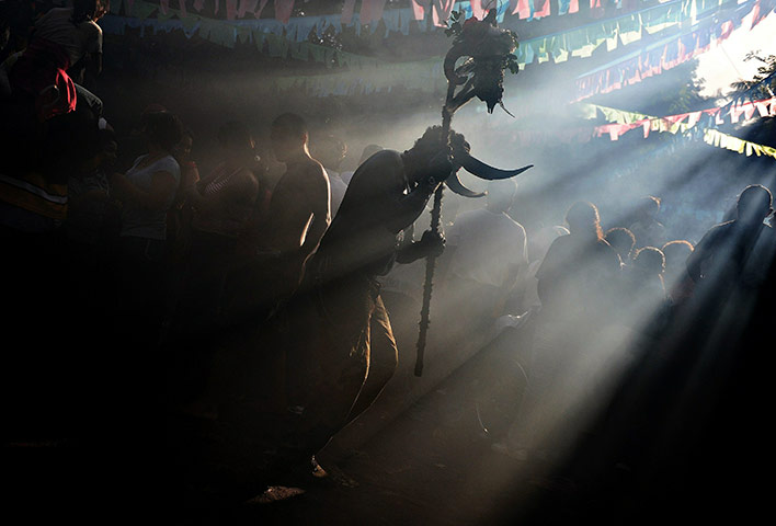 24 hours in pictures: A man dressed as a devil dances during f