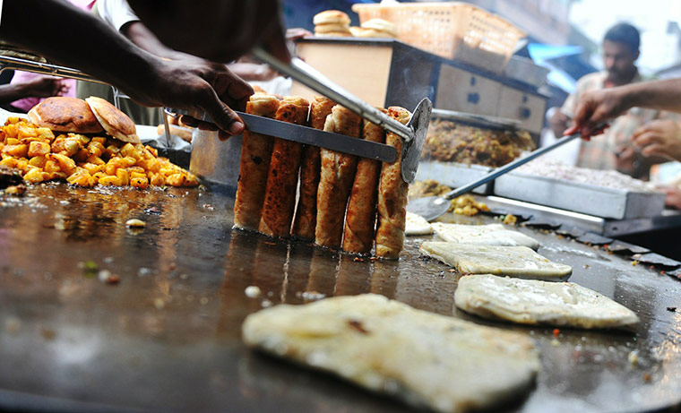 24 hours: Mumbai, India: An Indian Muslim vendor prepares food
