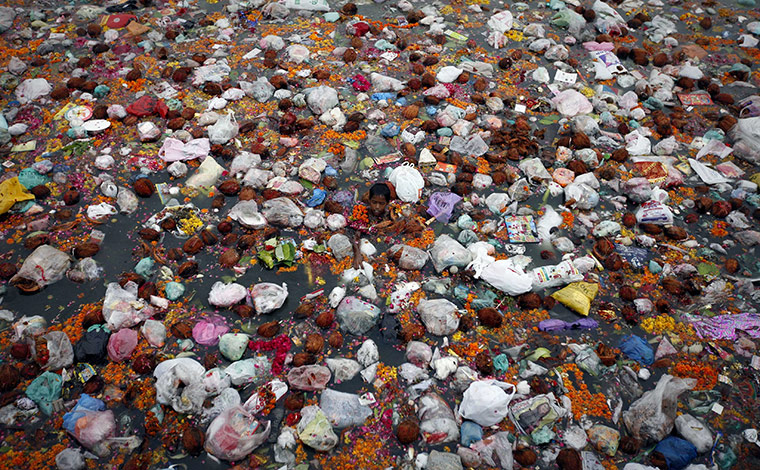 24 Hours: A boy swims in the polluted waters of the river Sabarmati in Ahmedabad
