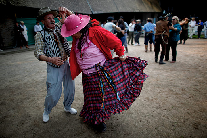 24 hours in pictures: Jauregui, Argentina: People dances during a rodeo 