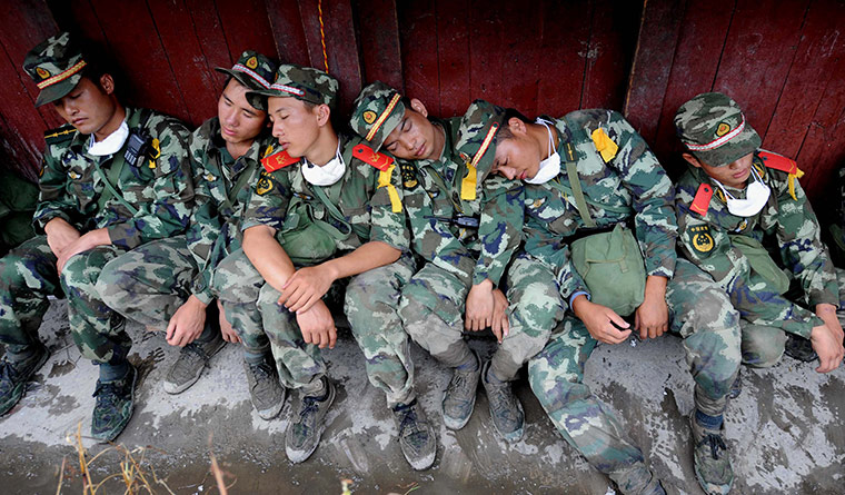 24 hours in pictures: Gongshan, China: Soldiers during operations to rescue landslide victims