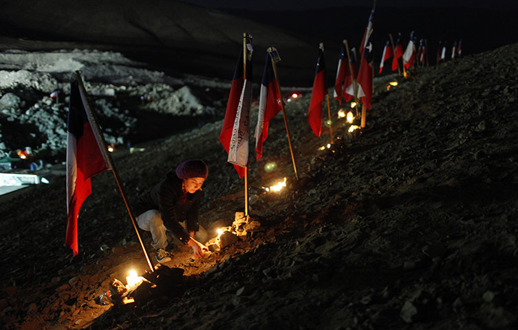 Chilean Miners Update: Andrea Aravena, relative of the trapped miners, lights candles