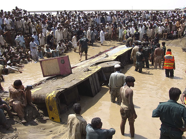 Pakistan Flood Update: Pakistani volunteers look for survivors of a passenger bus