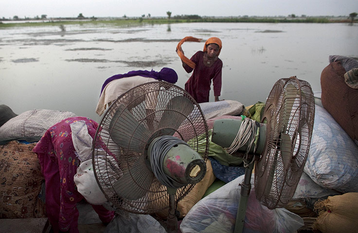 Pakistan Flood Update: Pakistani women  forced to flee their village organize their things