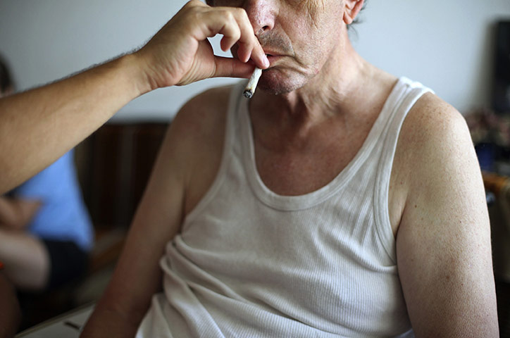 24 hours in pictures: Man helps cancer-stricken father smoke cannabis in Israel