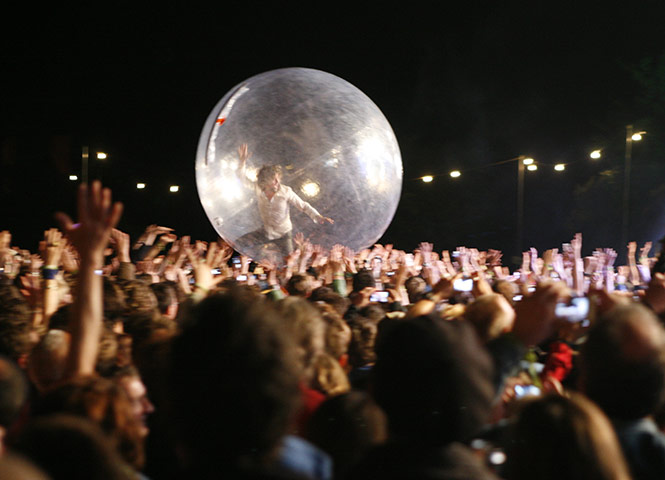 Green Man: Wayne Coyne of the Flaming Lips surfs the crowd
