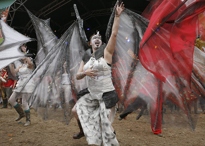 Green Man: Members of the parade dance through the festival site