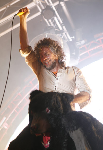 Green Man: Wayne Coyne sits on a bear's shoulders during his act 