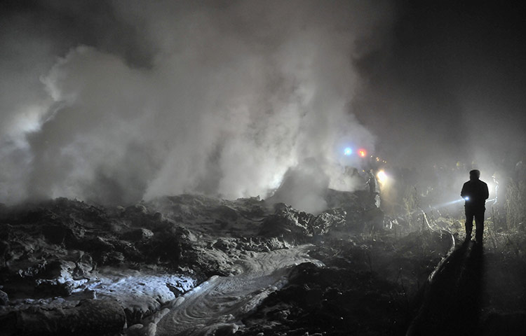 24 hours in pictures: Rescuers check the wreckage of a crashed passenger plane in Yichun
