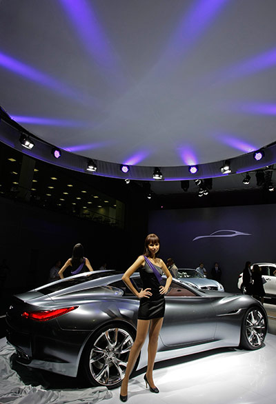 Moscow Auto Show: Models pose near Infiniti Essence at Moscow's International Auto Show
