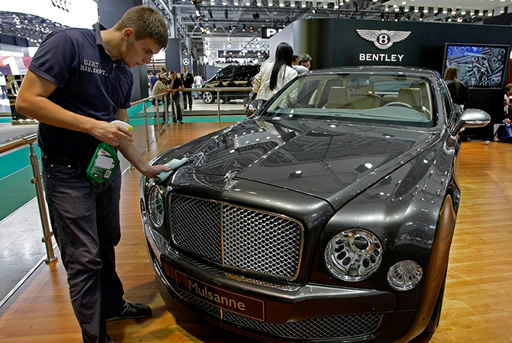Moscow Auto Show: A worker makes a final clean up of a Bentley Mulsanne