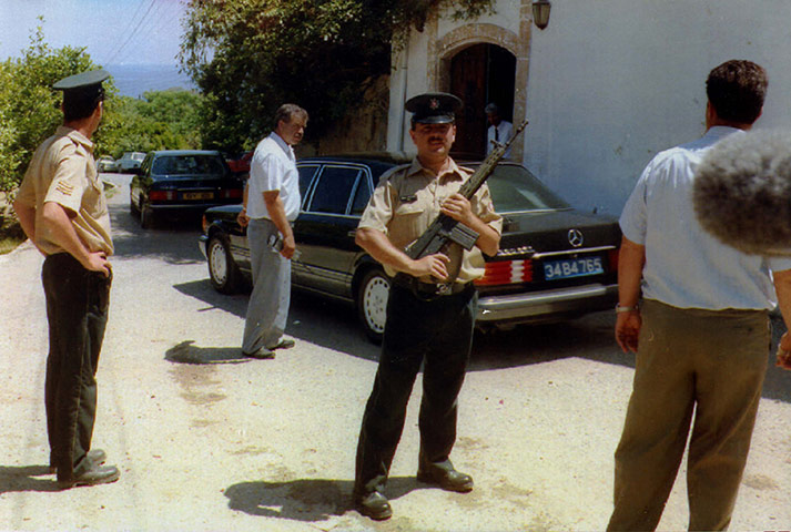 Asil Nadir: Armed Guards hold back the press as Tycoon Asil Nadir leaves his home