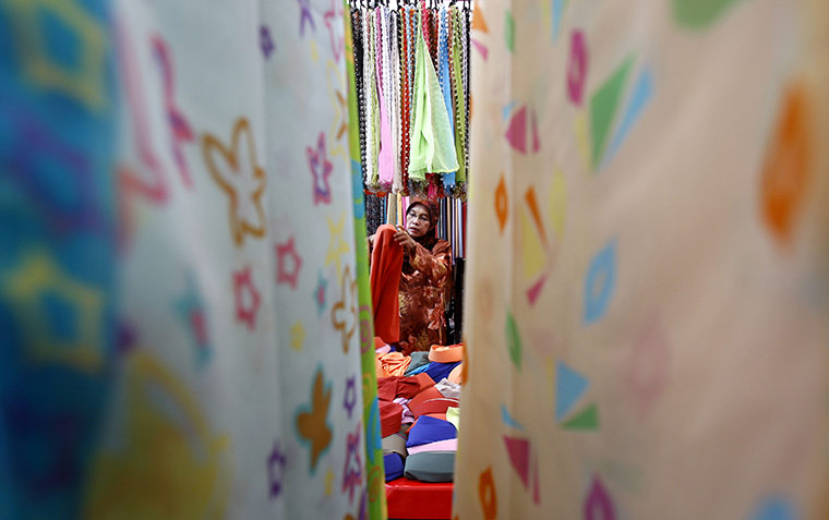 Ramadan Update: A Muslim woman selects a head scarf at a Ramadan bazaar in downtown Kuala Lumpur