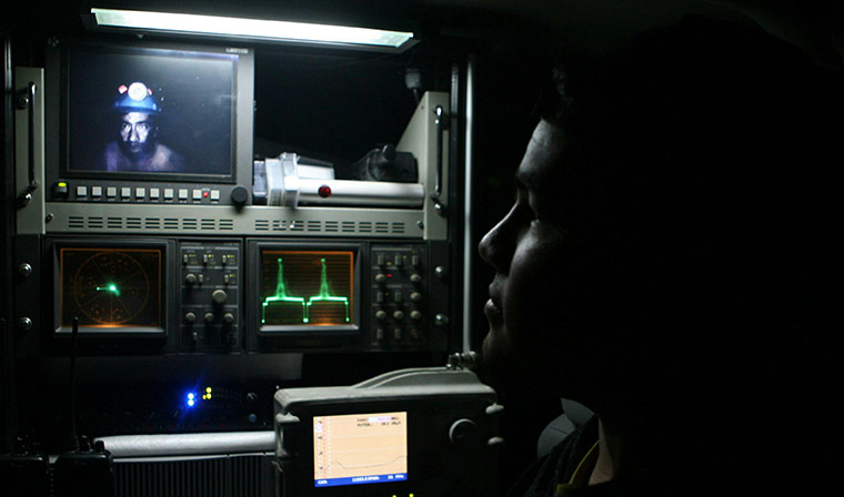 Chile Miners Update: Relatives watch on a  screen a video recorded of the trapped miners