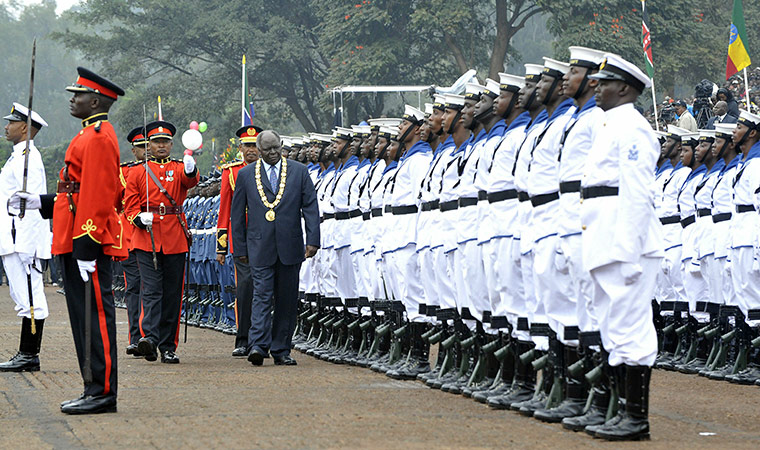 Kenya Constitution: Kenya's President Mwai Kibalki (C) reviews the guard of honour