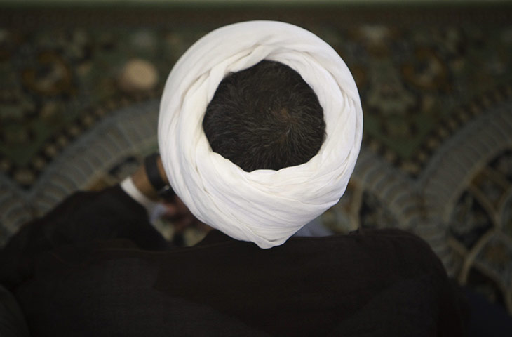 24 hours in pictures: Tehran, Iran: A cleric attend Friday prayers 