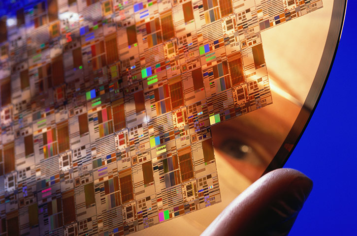 Business week in pictures:   	 Electronic engineer holding silicon chip wafer, close-up