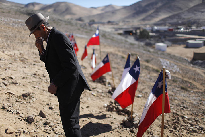 24 hours: Copiapo, Chile: Ramon Avalo, 81, wipes away tears where miners are trapped