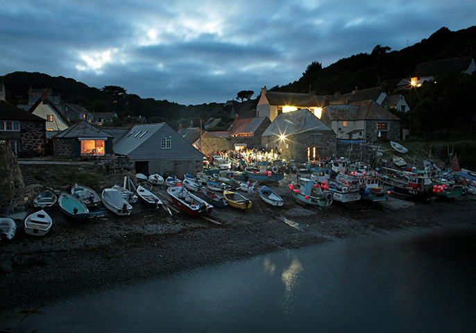 Helston fishing: People gather around the cove as fish are weighed in Cadgwith cove 