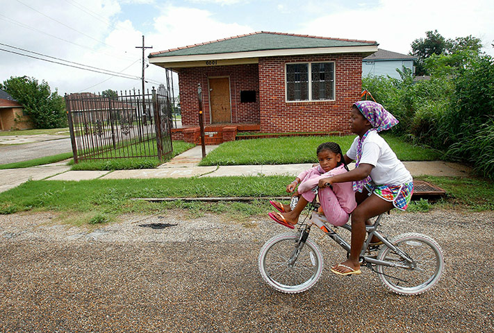 Obama in New Orleans: Darrion Welch, 9, cycles with her friend back to their homes