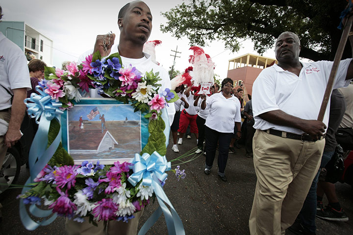 Obama in New Orleans: A man carries a commemorative wreath during a second line parade