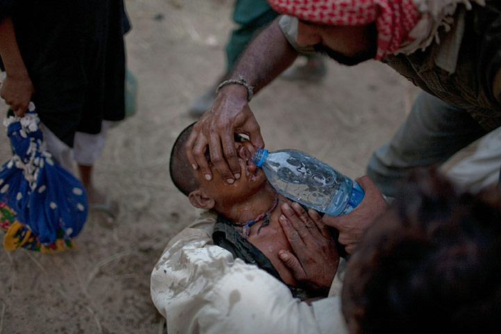 24 hours: Thatta, Pakistan: A young Pakistani boy is revived by fellow villagers 