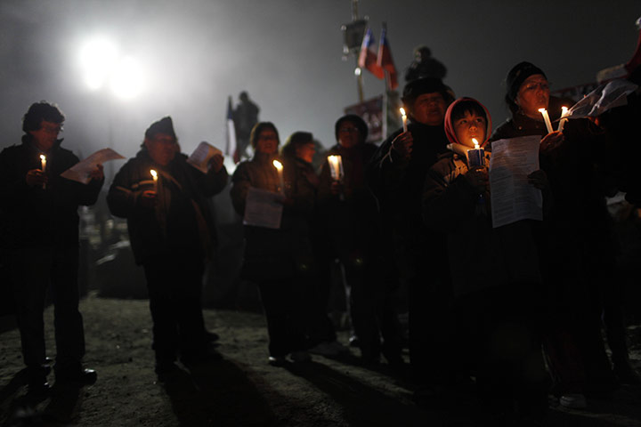 24 hours: Copiapo, Chile: Relatives of 33 trapped miners carry candles at a vigil 