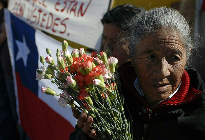 Miners in Chile: A relative of one of the trapped miners carries flowers 