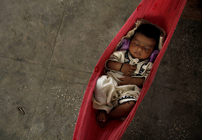 Pakistan Floods: Three-month-old Nasiba sleeps in a hammock in Sukkur, Pakistan