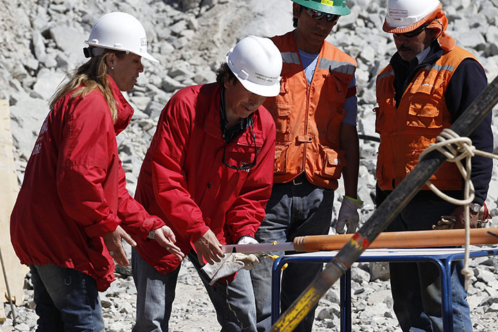 Miners in Chile: Chile's Mining Minister Laurence Golborne puts a camp bed in a tube
