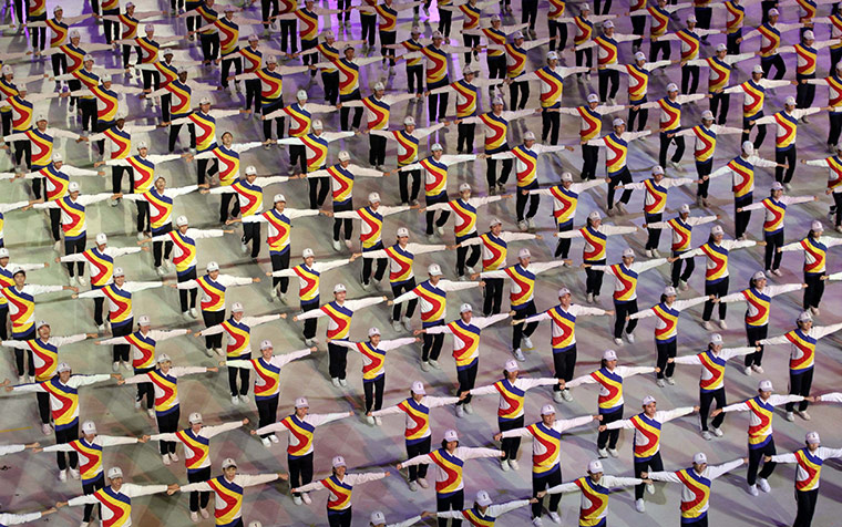 Malaysian Independence: Youths wearing the colours of the Malaysian national flag perform