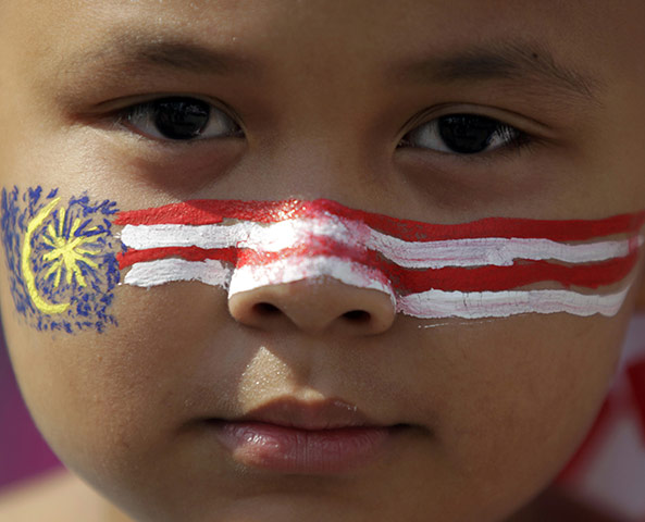 Malaysian Independence: A boy with the Malaysian national flag painted on his face