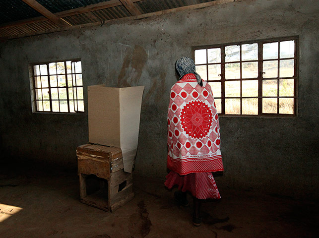 24 hours in pictures: A Masai woman prepares to mark her ballot paper at a polling station, Kenya