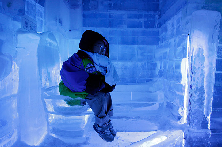 24 hours in pictures: A South Korean boy sits on the ice toilet at Ice Gallery