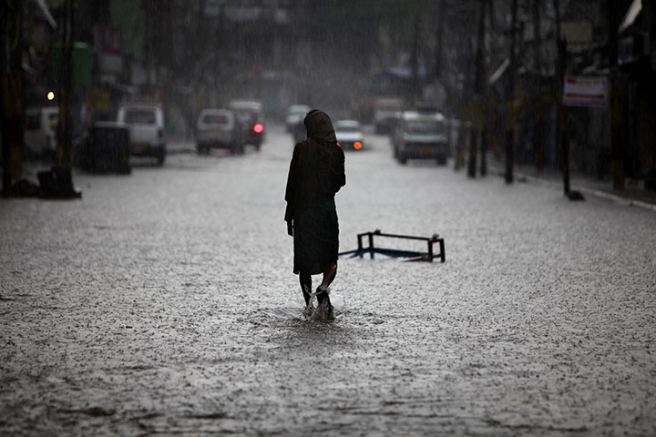24 hours in pictures: Jammu, India: A man wades though a flooded street 