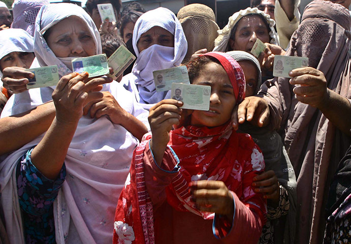 Pakistan update: Flood victims show their national identity card to get food relief 