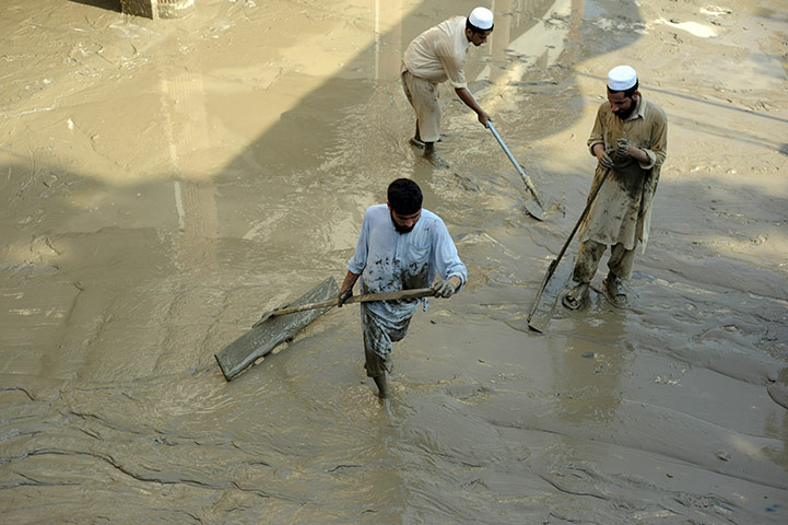 Pakistan update: Pakistani religious students clean a mosque after flash floods in Nowshera