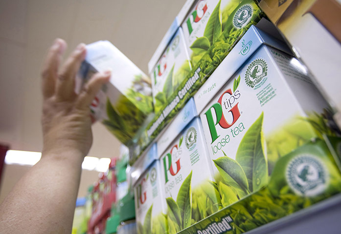 Week in business: A customer selects a box of PG Tips teabags, produced by Unilever Plc