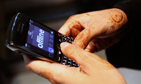 A woman uses her Blackberry mobile device at a shopping mall in Dubai